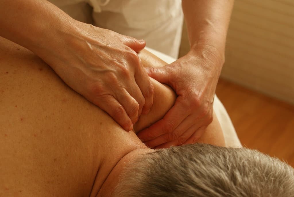 Man receiving shoulder massage for rotator cuff pain